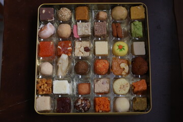 multicolored variety of indian sweets from different parts of the  states
