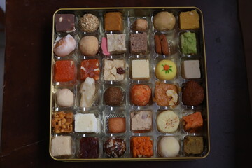 multicolored variety of indian sweets from different parts of the  states