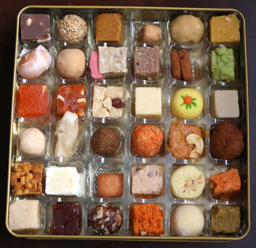 multicolored variety of indian sweets from different parts of the  states