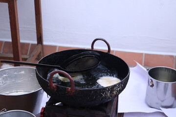 poori, puri deep fried in hot oil pot