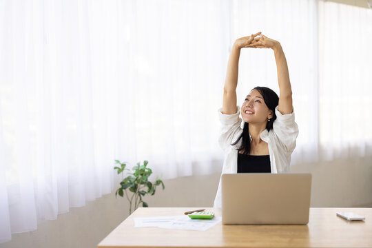 Woman Stretching During Work Break at Desk