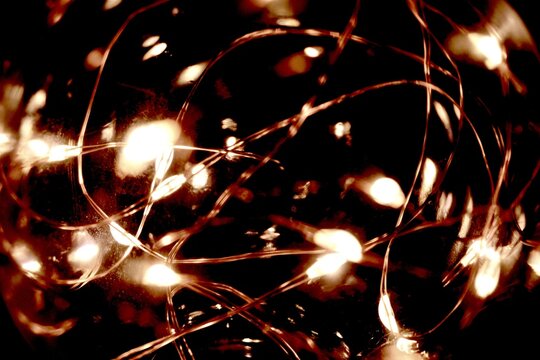 Close-up of big buld with tiny lights. Abstract background with lighting. Black background with lights.