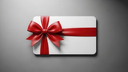 Elegant white gift card with a luxurious red satin ribbon and bow, isolated.