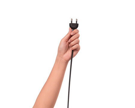 Close-up of a hand holding a black electric power cord plug isolated on transparent PNG.	
