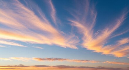 Beautiful vibrant sky with wispy orange and pink clouds at sunset, creating a dramatic and peaceful natural backdrop and serene atmosphere