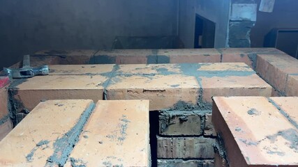 Construction of a heating stove. Demonstration of the upper row brickwork of the stove.