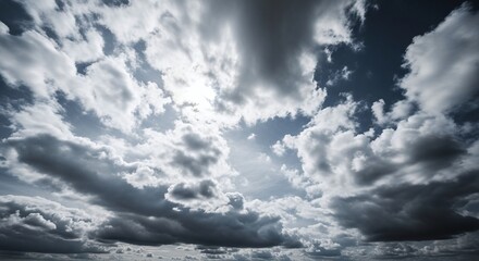 Dramatic sky with powerful, dark clouds and bright sunlight breaking through, creating a dynamic and moody atmosphere