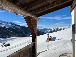 Old traditional swiss rural architecture and alpine livestock farms in the winter ambience of the alpine Swiss village St. Ant&ouml;nien - Canton of Grisons, Switzerland (Kanton Graub&uuml;nden, Schweiz)