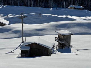 Old traditional swiss rural architecture and alpine livestock farms in the winter ambience of the alpine Swiss village St. Ant&ouml;nien - Canton of Grisons, Switzerland (Kanton Graub&uuml;nden, Schweiz)