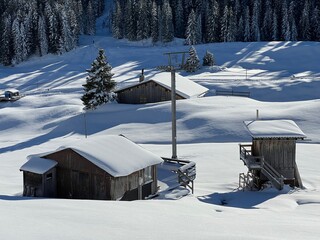 Old traditional swiss rural architecture and alpine livestock farms in the winter ambience of the alpine Swiss village St. Ant&ouml;nien - Canton of Grisons, Switzerland (Kanton Graub&uuml;nden, Schweiz)