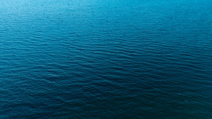 Obraz premium Top view of deep blue sea water surface with small ripples, aerial drone shot of turquoise ocean texture at island , abstract nature background 