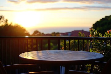 Empty wooden table on a balcony at sunset