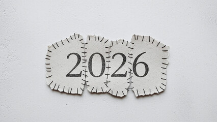 Minimal Stitched 2026 on Textured Fabric Patches for Clean New Year Design. Handmade Fabric Numbers for a Soft New Year Theme. Cute Patchy 2026 Numbers on Soft Fabric Pieces
