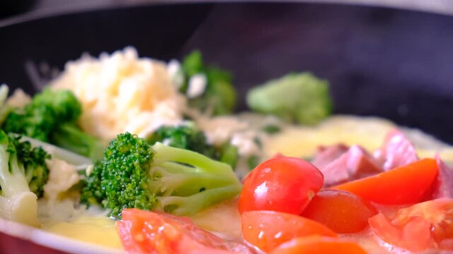 Stir-fried mixed vegetables and a fried egg on pan, healthy meal with vitamins and protein. Kind of Italian omelette with vegetables. Frittata