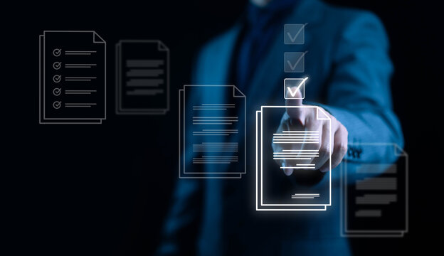 A businessman selecting a digital document with a glowing check mark representing workflow management document approval business process optimization and modern technology in professional environments
