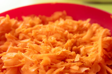Close-up of grated carrot in a bowl