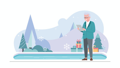 Happy senior man shopping online using a tablet in a snowy winter landscape surrounded by gifts