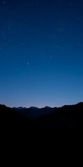 Dark to light blue gradient night sky above mountain silhouettes, scattered stars,  gradient,  nature