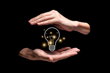 New idea with light bulb concept on black background. A light bulb held by hands. Illuminated bulb represents of inspiration, solution, and creativity 