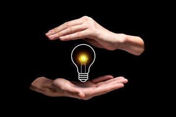 Creative idea with light bulb concept on black background. A light bulb held by hands. Illuminated bulb represents of new idea, solution, and inspiration 