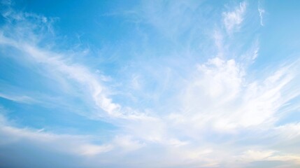 Fototapeta premium Dreamy pastel sky with soft wispy clouds — serene blue and white cloudscape, ethereal atmospheric background for wallpaper, banner, web design and nature-themed projects