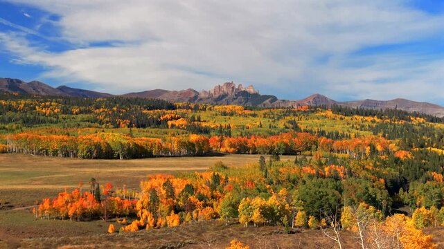 Crested Butte Ohio Kebler Pass Colorado aerial drone parallax The Castle Mountain Mill Castle Gunnison National Forest morning autumn fall Aspen tree colors blue sky clouds farmland upwards motion