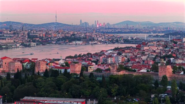 Bosphorus Strait ferry boats harbor view sunset golden hour pink purple sky afterglow Istanbul Turkey T&uuml;rkiye aerial drone panoramic landscape cityscape buildings city skyscrapers forward pan up