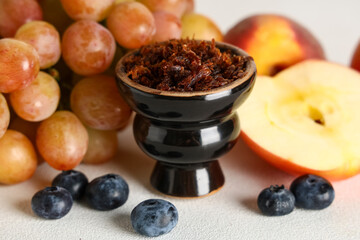 Hookah bowl of tobacco with berries and fruits on white background