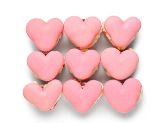 Fototapeta premium Many sweet heart-shaped macaroons on white background. Valentine's Day celebration