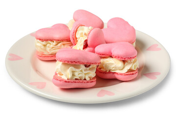 Plate with sweet heart-shaped macaroons on white background. Valentine's Day celebration