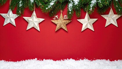 Festive Christmas stars and snowy fir branches on a red background.