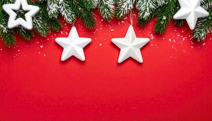 Festive Christmas fir branches with white star ornaments on a vibrant red background with snow effect.