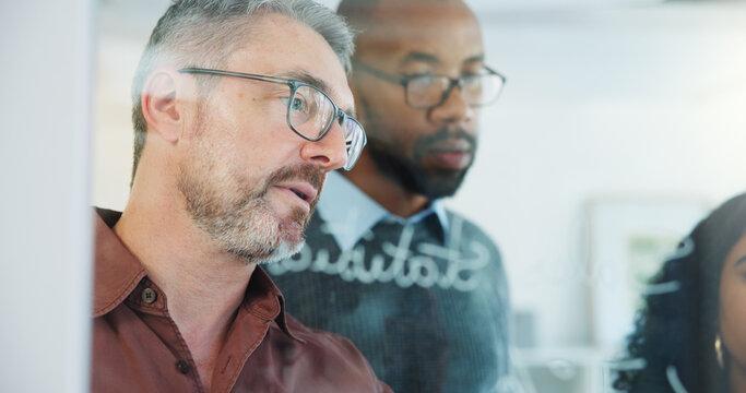 Man, team and writing on glass wall at office, planning or insight with risk management solution. Mature person, group and notes on board for problem solving, strategy or feedback at insurance agency - Powered by Adobe