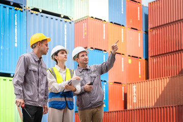 Diverse Logistics Team Inspecting and Pointing to Shipping Containers at Port Terminal, Engineers Planning Cargo Stacking and Inventory Management in the Yard, Supervisor Directing Work Flow