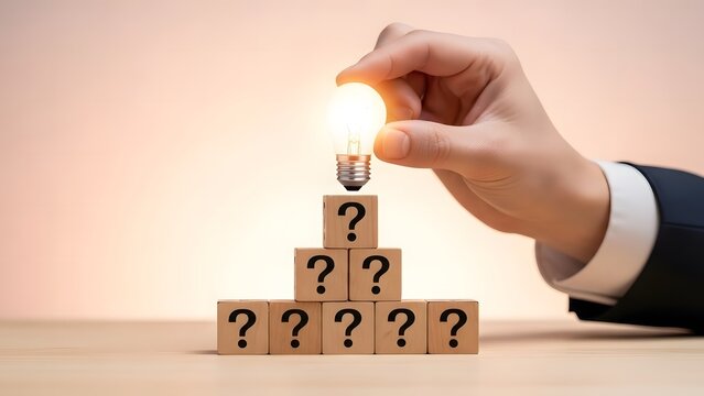 Finding the answer lightbulb on question mark wooden blocks