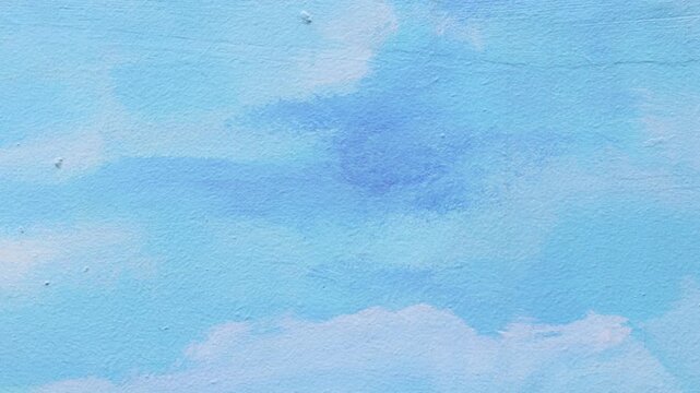 Blue painted wall with cloud like texture and chaotic brush strokes background