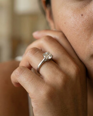 Woman Admiring Diamond Ring in Soft Light