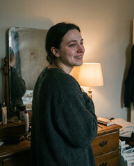 Woman with a soft smile in a quiet moment of self-acceptance.