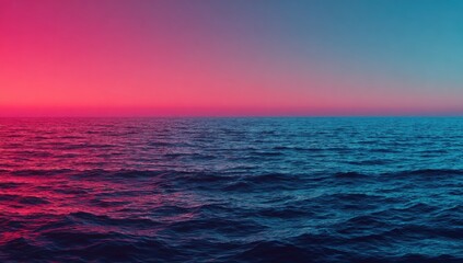 Fototapeta premium Ocean surface at twilight with pink and blue sky.