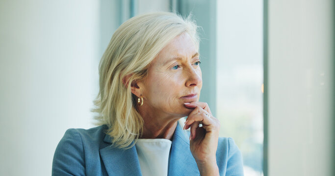 Planning, window and mature businesswoman in office with brainstorming, thinking or decision. Glasses, ideas and female executive CEO in workplace with choice, reflection or opportunity for company.