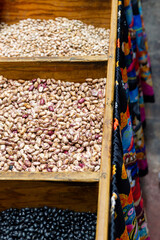 Close Up of Assorted Dried Bean Variety in Wooden Container on Display