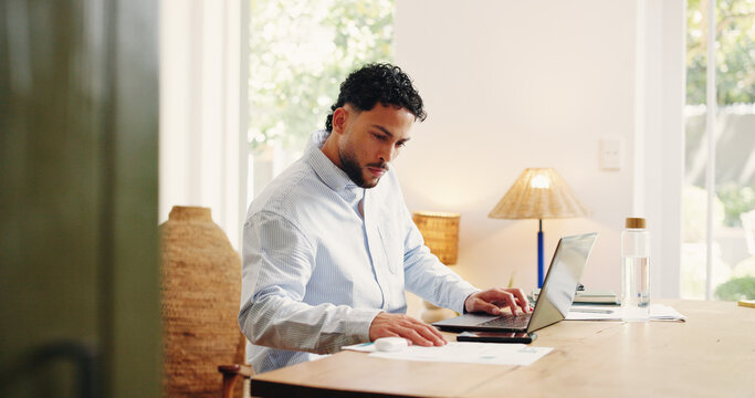 Documents, laptop and reading with business man in home office for problem solving or research. Computer, paperwork and planning with freelance employee at desk in apartment for remote work startup