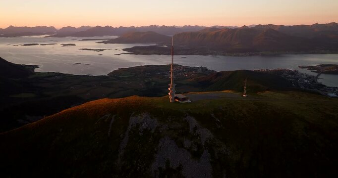 TV and radio tower atop Storheia mountain during sunset in Stokmarknes. Aerial