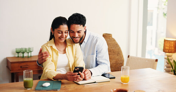 Happy, hug and couple with phone in home for online booking, holiday resort and travel website. Apartment, love and man with woman on smartphone for hotel reviews, planning vacation and research