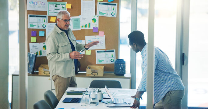 Businessmen, documents and meeting with pinboard for analytics or performance review in office. Men, employees or creative team with paperwork on board for project planning or statistics in workplace - Powered by Adobe