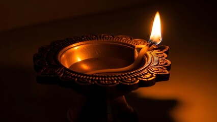 Traditional Brass Oil Lamp with Burning Wicks in Warm Dim Light for Cultural and Spiritual Celebrations