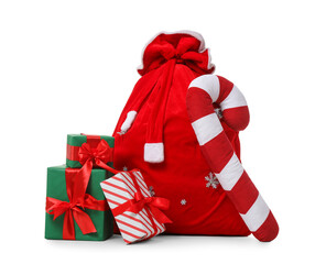 Santa Claus bag, gifts and candy cane isolated on white background