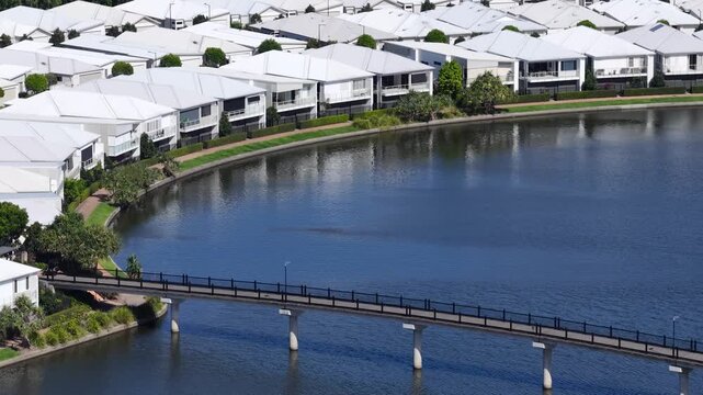 Aerial View of Lakefront Houses and Pedestrian Bridge