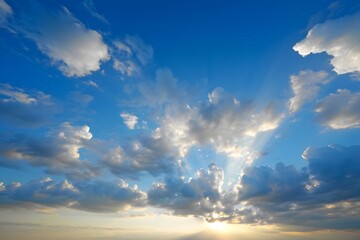 Radiant sunbeams piercing through the fluffy clouds in the vast azure sky above us all