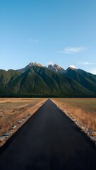 Road leading to mountains under a clear sky in a scenic landscape view outdoors